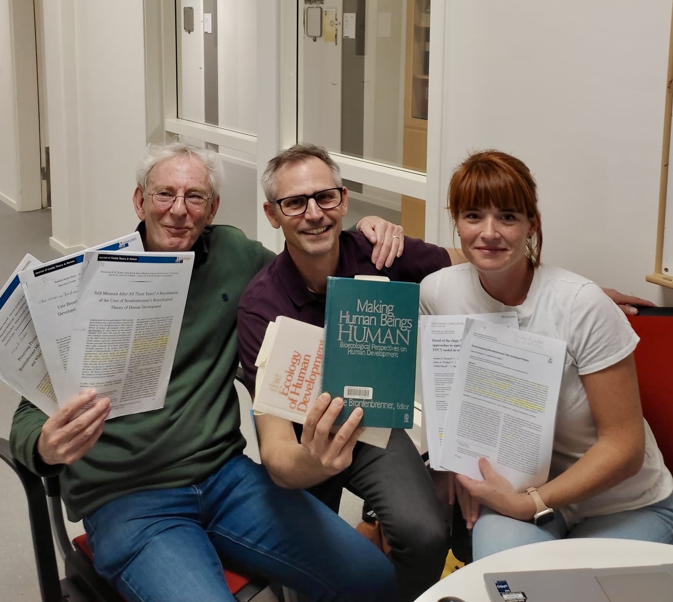 Jessica Navarro with colleagues and Bronfenbrenner books